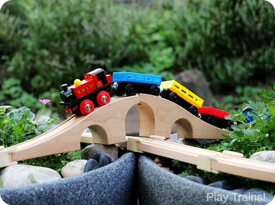 Super easy way to make a DIY outdoor wooden train "table"...no tools required to make this mini garden railway!
