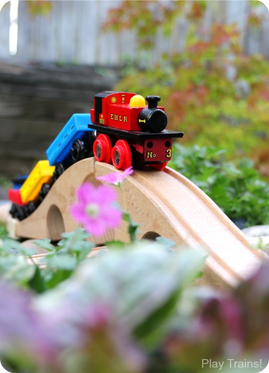 Super easy way to make a DIY outdoor wooden train "table"...no tools required to make this mini garden railway!