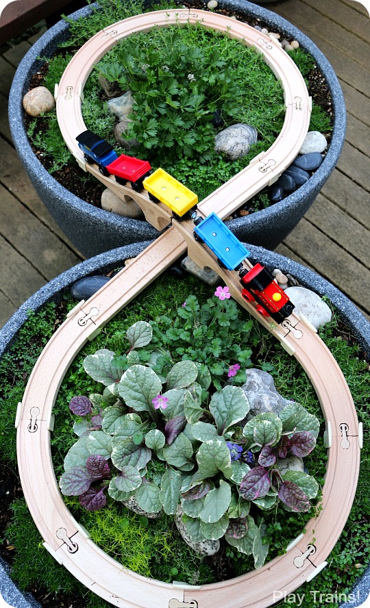 Super easy way to make a DIY outdoor wooden train "table"...no tools required to make this mini garden railway!