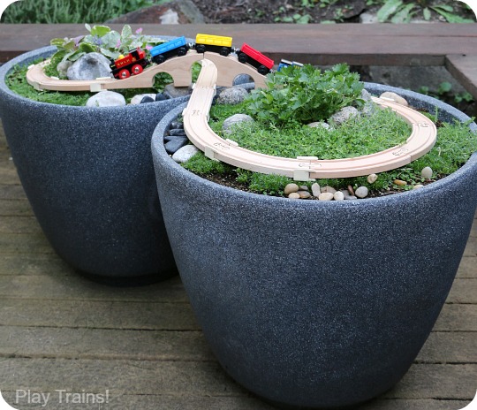 Super easy way to make a DIY outdoor wooden train "table"...no tools required to make this mini garden railway!