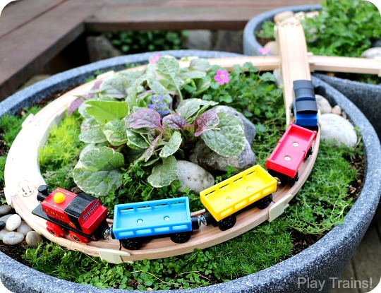 Super easy way to make a DIY outdoor wooden train "table"...no tools required to make this mini garden railway!