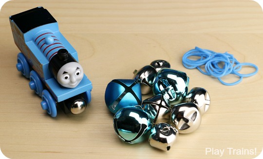 Jingle Trains: how to temporarily turn wooden trains into wooden train jingle bell shakers! Fun for ringing along with Christmas carols or for music activities all year long. http://play-trains.com/