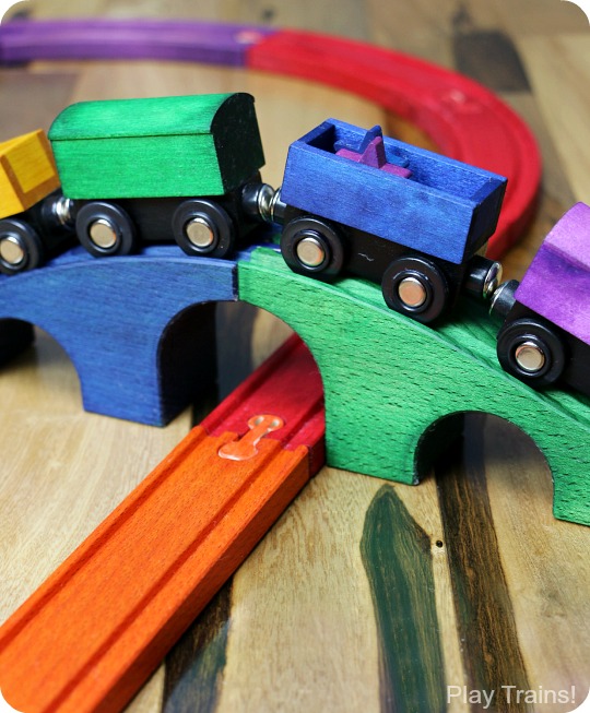 DIY Rainbow Wooden Train: beautiful, vibrant, non-toxic dye brightens up a wooden train set, inspired by the book 150+ Screen-Free Activities for Kids! Perfect for playing out the classic board book, Freight Train by Donald Crews.