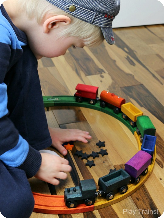 DIY Rainbow Wooden Train: beautiful, vibrant, non-toxic dye brightens up a wooden train set, inspired by the book 150+ Screen-Free Activities for Kids! Perfect for playing out the classic board book, Freight Train by Donald Crews.